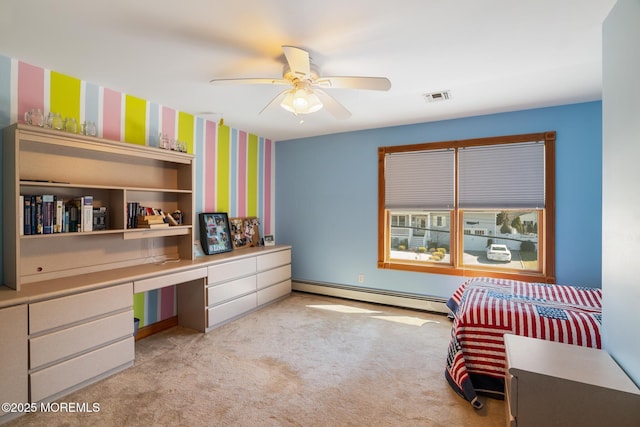 office space featuring visible vents, baseboard heating, carpet flooring, built in study area, and a ceiling fan