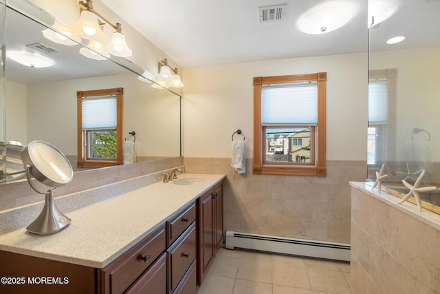 full bathroom with tile patterned floors, baseboard heating, tile walls, and visible vents