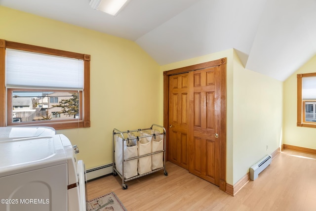 laundry area with independent washer and dryer, light wood-style flooring, baseboards, baseboard heating, and laundry area