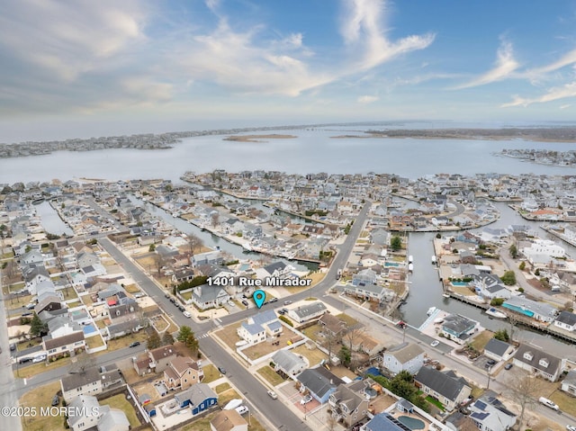 bird's eye view with a water view and a residential view