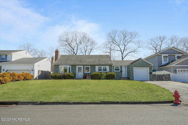 view of front facade featuring aphalt driveway, a front lawn, a garage, and fence