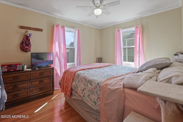 bedroom featuring crown molding, multiple windows, and wood finished floors