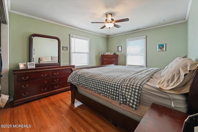 bedroom with ceiling fan, wood finished floors, and ornamental molding