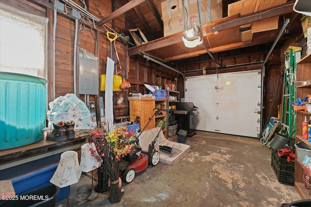 garage with electric panel and a garage door opener