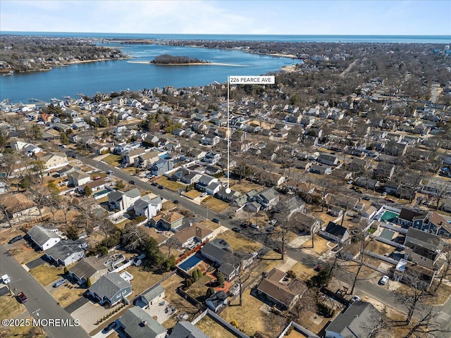 drone / aerial view with a residential view and a water view