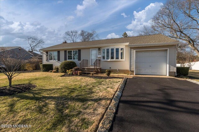 single story home with aphalt driveway, an attached garage, a front yard, and fence