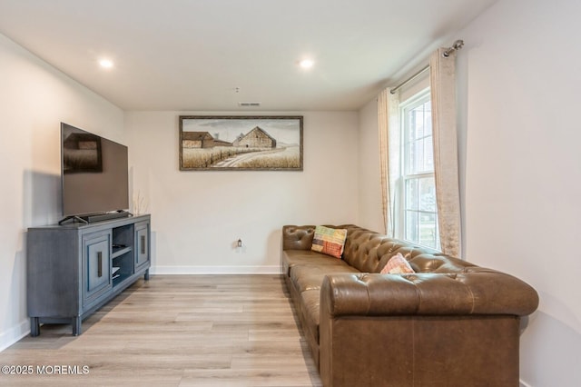 living area with recessed lighting, visible vents, baseboards, and light wood finished floors