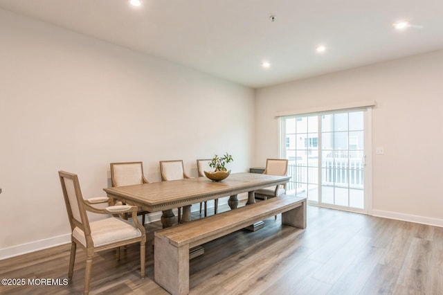 dining room with recessed lighting, baseboards, and wood finished floors