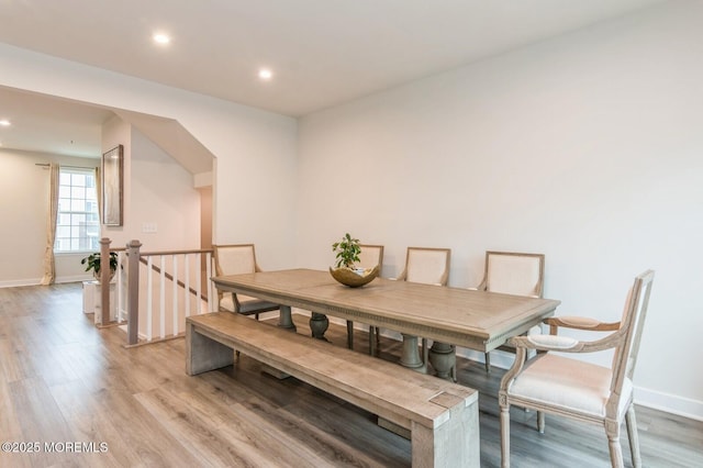 dining room with recessed lighting, light wood-type flooring, and baseboards