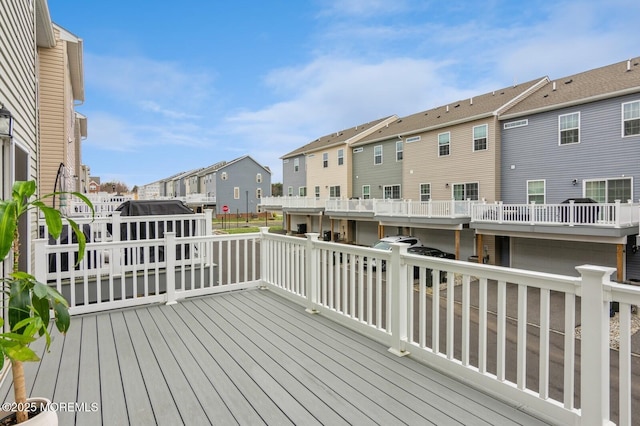 wooden terrace featuring a residential view