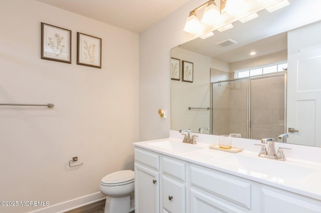 full bath featuring a sink, visible vents, tiled shower, and double vanity