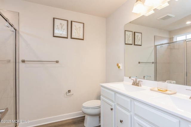 full bath with visible vents, toilet, baseboards, and a sink