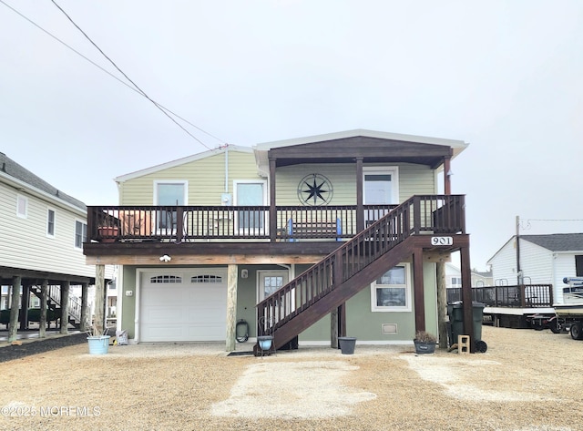 view of front of home featuring stairs, a garage, and driveway