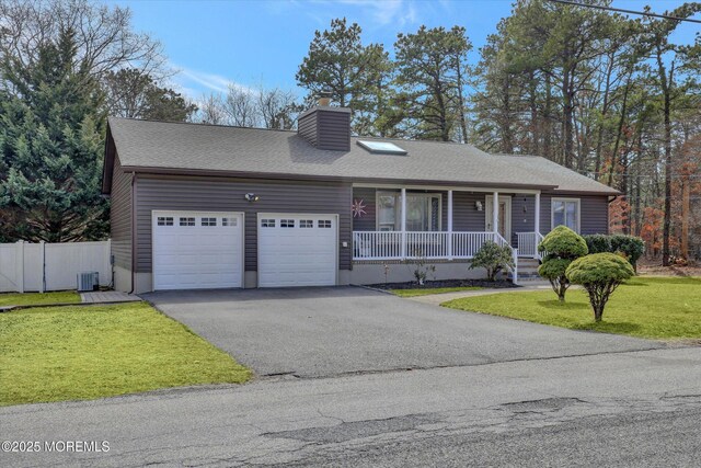 1500 First Ave, Toms River, NJ 08757 - view of front of home with cooling unit, fence, covered porch, a garage, and aphalt driveway