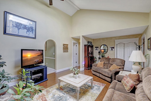 1500 First Ave, Toms River, NJ 08757 - living room with baseboards, ceiling fan, wood finished floors, arched walkways, and high vaulted ceiling