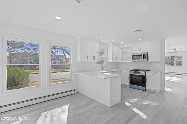 1 Redlands Ct, Toms River, NJ 08757 - kitchen featuring a sink, a baseboard heating unit, appliances with stainless steel finishes, white cabinets, and open shelves