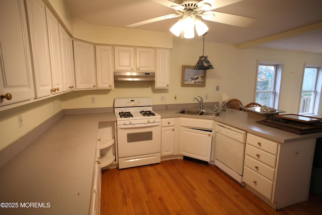 16 Ensor Pl, Island Heights, NJ 08732 - kitchen featuring white appliances, a sink, under cabinet range hood, a peninsula, and white cabinets