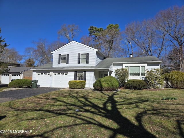 view of front of property with a front yard, an attached garage, driveway, and a chimney