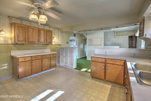 415 Parkview Ave, Ocean Twp, NJ 07712 - kitchen featuring a sink, light countertops, a ceiling fan, wallpapered walls, and light floors