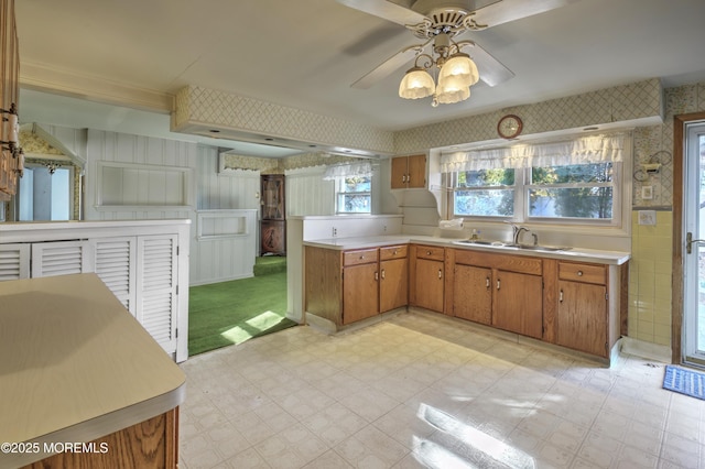 415 Parkview Ave, Ocean Twp, NJ 07712 - kitchen featuring light countertops, wallpapered walls, a sink, and light floors