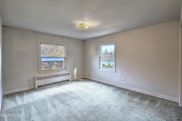 415 Parkview Ave, Ocean Twp, NJ 07712 - carpeted empty room featuring baseboards, radiator, and a healthy amount of sunlight