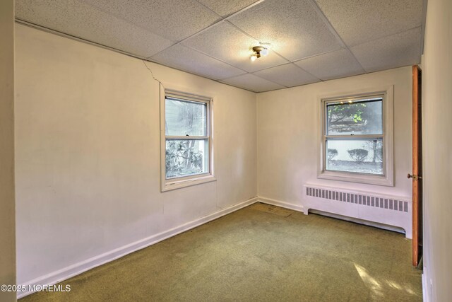 415 Parkview Ave, Ocean Twp, NJ 07712 - unfurnished room featuring a paneled ceiling, radiator heating unit, carpet flooring, and a wealth of natural light