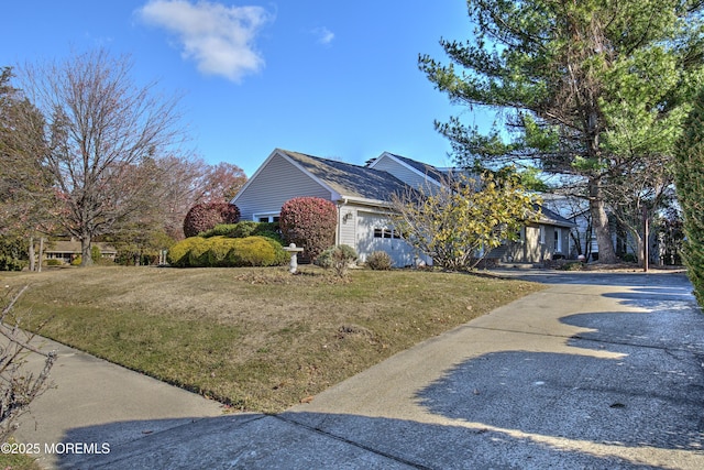 415 Parkview Ave, Ocean Twp, NJ 07712 - view of side of home featuring a yard, an attached garage, and concrete driveway