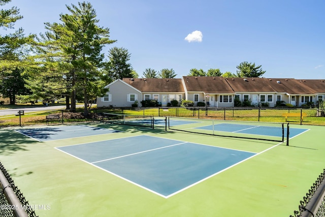 view of tennis court featuring fence