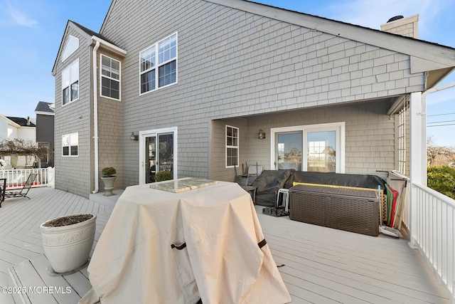 wooden deck featuring an outdoor hangout area, outdoor dining area, and area for grilling