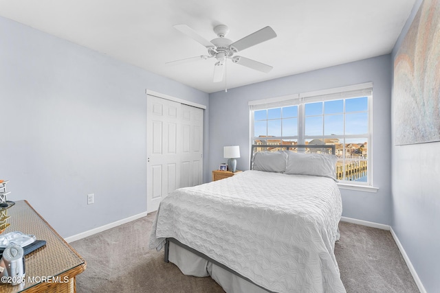bedroom with carpet floors, a closet, baseboards, and ceiling fan