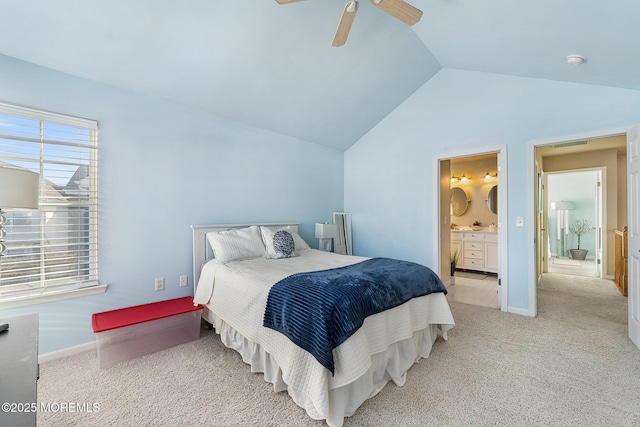 bedroom with connected bathroom, vaulted ceiling, carpet flooring, and baseboards