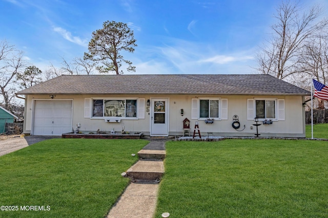 ranch-style home featuring aphalt driveway, a shingled roof, a garage, and a front yard