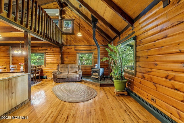 461 Harmony Rd, Jackson, NJ 08527 - living room featuring a wood stove, healthy amount of natural light, high vaulted ceiling, wood ceiling with exposed beams, and hardwood / wood-style floors