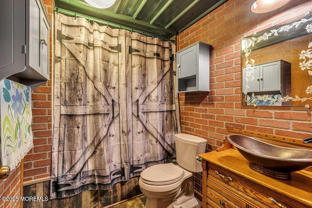 461 Harmony Rd, Jackson, NJ 08527 - full bathroom featuring brick wall, vanity, toilet, and a shower with curtain