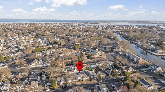 drone / aerial view featuring a residential view and a water view