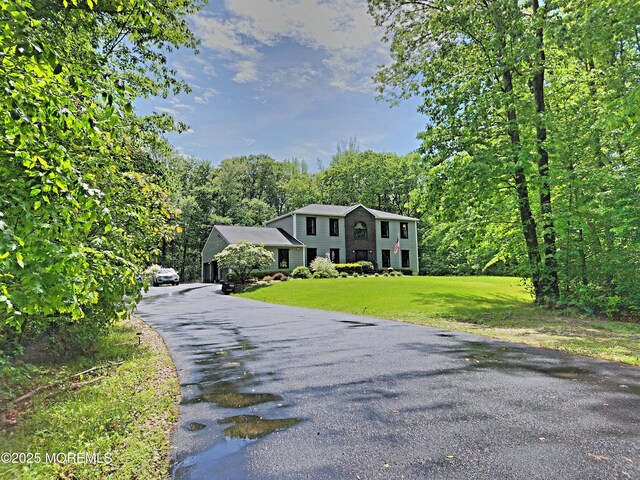 119-127 Broadway Rd, Cranbury, NJ 08512 - colonial house with a front lawn, asphalt driveway, and a wooded view