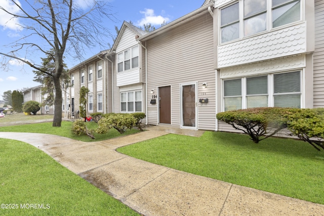 townhome / multi-family property with a front lawn
