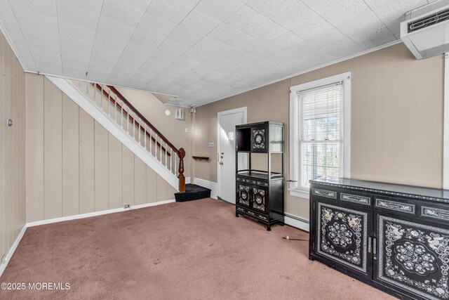 basement featuring baseboards, stairs, and carpet floors