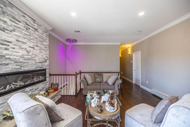 living area with wood finished floors, visible vents, baseboard heating, and ornamental molding