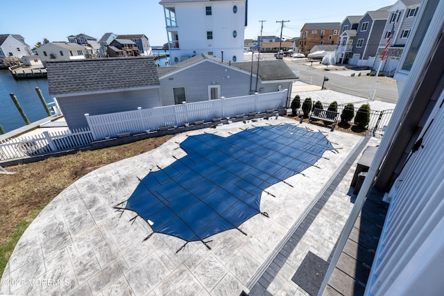 view of swimming pool with a fenced backyard, a residential view, a patio, and a fenced in pool