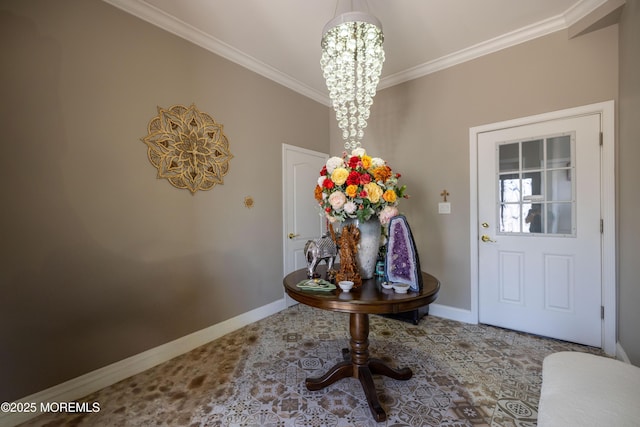 foyer entrance with baseboards, ornamental molding, and a chandelier
