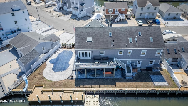 drone / aerial view with a water view and a residential view