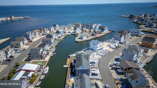 drone / aerial view featuring a residential view and a water view