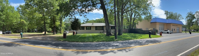 185 W Commodore Blvd, Jackson, NJ 08527 - view of front of home featuring a garage, a front yard, concrete driveway, and metal roof