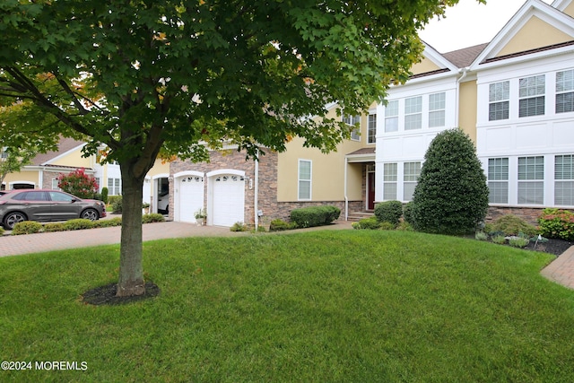 26 Aspen Ln, Tinton Falls, NJ 07724 - view of front of property with a front yard, driveway, and stucco siding