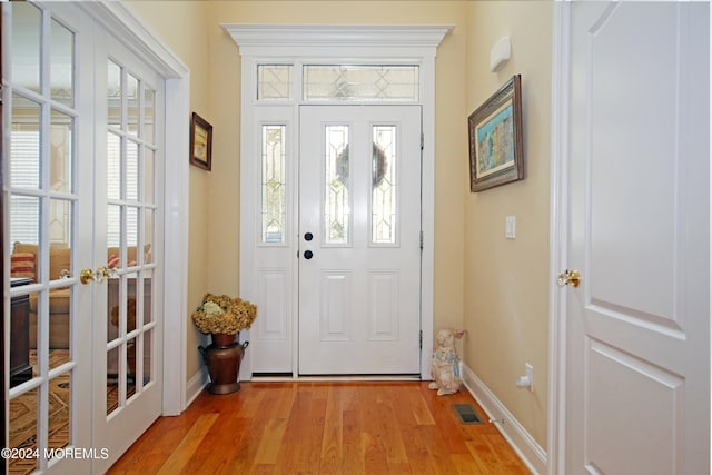 26 Aspen Ln, Tinton Falls, NJ 07724 - foyer entrance with light wood-type flooring, french doors, and baseboards