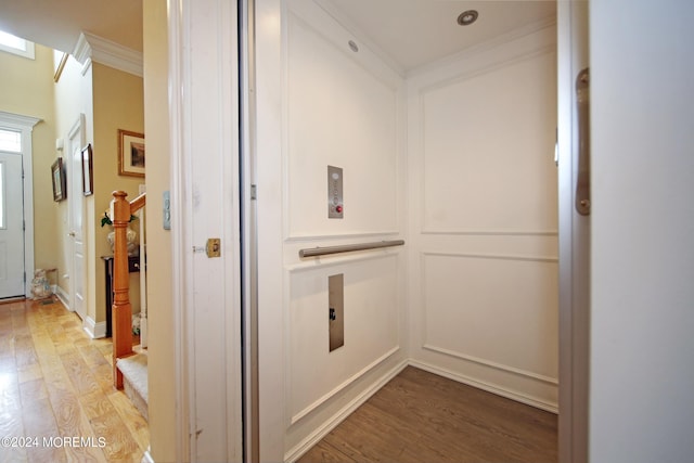 26 Aspen Ln, Tinton Falls, NJ 07724 - hallway with elevator, crown molding, and light wood-type flooring