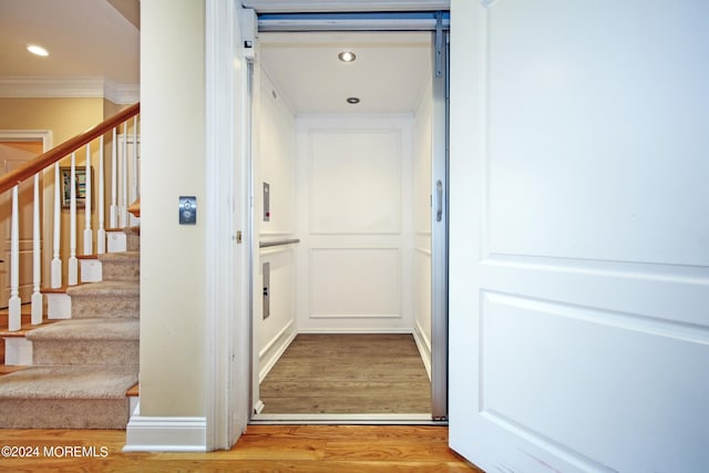 26 Aspen Ln, Tinton Falls, NJ 07724 - hall with crown molding, stairway, elevator, recessed lighting, and wood finished floors