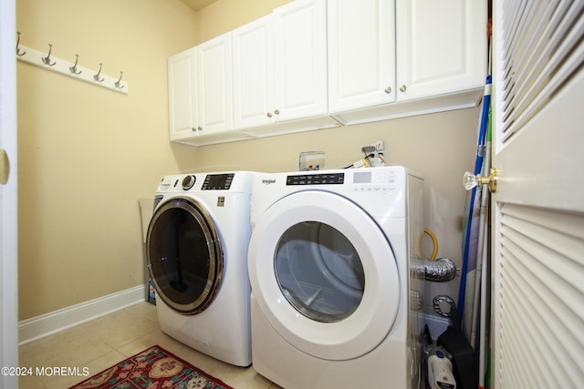 26 Aspen Ln, Tinton Falls, NJ 07724 - laundry area with light tile patterned floors, baseboards, cabinet space, and washer and clothes dryer