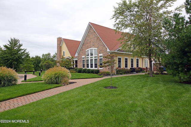 26 Aspen Ln, Tinton Falls, NJ 07724 - rear view of property featuring stone siding and a lawn